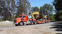 A gooseneck lowboy trailer with an oversized load