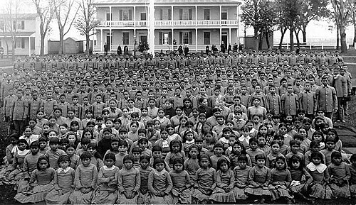 The Carlisle Indian Industrial School was a major institution for the assimilation of Native Americans. From 1879 until 1918, over 10,000 children from 140 tribes attended Carlisle.[237] Founded by Richard Henry Pratt, his motto, "Kill the Indian, Save the Man", was in reference to the ethics of the school and efforts to eradicate Indigenous culture and forcibly assimilate the Natives into white American culture, and that "the goal of acculturation was to be accomplished by "total immersion" in the white man's world."[238][239]