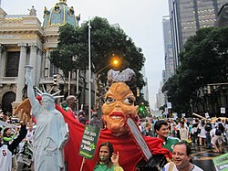 Demonstration at Rio+20. Picture shows effigy of Brazilian President Dilma Rousseff with a chainsaw and embracing a replica of the Statue of Liberty.