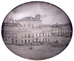 Photograph showing the Imperial Palace in Rio de Janeiro with carriages and mounted honor guard in the square fronting the palace