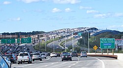 The Governor Alfred E. Driscoll Bridge on the Garden State Parkway crosses the Raritan River near its mouth at the Raritan Bay. The bridge, connecting the communities of Woodbridge Township to the north and Sayreville to the south, is the world's widest and one of the busiest motor vehicle bridges[105]