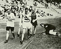 A track-side judge monitoring technique at the 1912 Summer Olympics in Stockholm, Sweden
