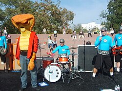 "Cobraman" crashes a show in 2008. Costumed characters are staples of The Aquabats' concerts, appearing as part of mock fights or comedic skits.