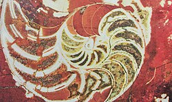 A giant nautilus in red marble on the wall on Moscow Metro