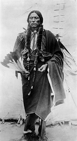 Quanah Parker, prominent chief of the Comanche Indians with a feather fan; photo by James Mooney, 1892