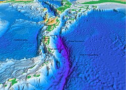 The subduction of the South American Plate and part of the North American Plate beneath the Caribbean Plate produces both the Puerto Rico Trench, the deepest part of the Atlantic Ocean, as well as the active volcanoes of the Lesser Antilles (bottom left of the image, south of the Virgin Islands)