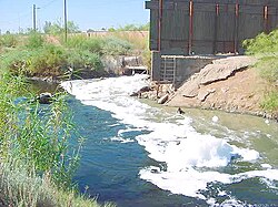 Siltation caused by raw sewage sludge and industrial waste in the New River as it passes from Mexicali to Calexico, California.