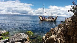 Isla del Sol in Bolivia, with a raft made from totora on Lake Titicaca