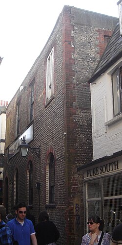 The east wall, in a traditional Sussex style with cobbled stones, flints and red brick dressings