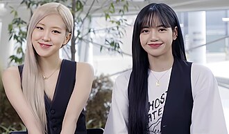 Rosé (left) and Lisa (right) in a promotional video for PUBG Mobile in 2021