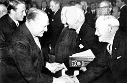 The Nobel Peace Prize ceremony in 1963 when the prize was jointly awarded to the ICRC and the Federation. From left to right: King Olav of Norway, ICRC President Leopold Boissier, League chairman John MacAulay.