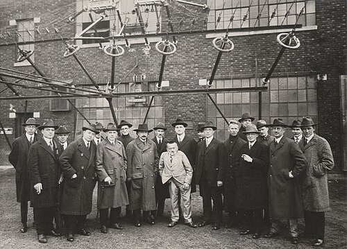 Early pioneers of radio science and technology in the United States, including Charles Steinmetz, David Sarnoff, Irving Langmuir, and Alfred Goldsmith in 1921, photographed next to the antenna feed wires of the New Brunswick Marconi Station, one of the first transatlantic radio links. The photo includes Albert Einstein as a visiting guest.