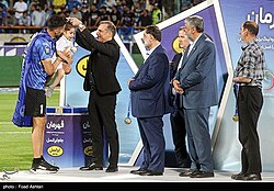 Hosseini receiving 2021–22 Iran Pro League championship medal