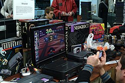 A collection of various classic video game consoles at a game show in 2010