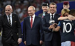 Kylian Mbappé receiving the World Cup best young player award from Emmanuel Macron