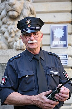 German State Police officer in Hamburg, with the rank of Polizeihauptmeister mit Zulage ("police chief master with upgraded pay")