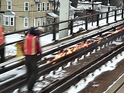 A pull-apart on the Long Island Rail Road Babylon Branch being repaired by using flaming rope to expand the rail back to a point where it can be joined together