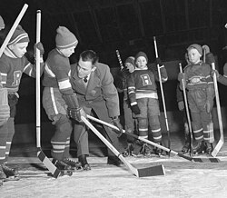 Youths being taught how to properly deliver a check in ice hockey.