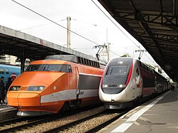 TGV Sud-Est (left), the first equipment used on the service; and TGV 2N2 (right), the newest equipment used on the service, at Gare de Lyon, 2019