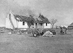 A British response to the guerrilla war was a scorched earth policy to deny guerrillas supplies and refuge. Here Boer civilians watch their house as it is burned.