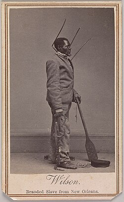 Wilson Chinn, a branded slave from Louisiana—also exhibiting instruments of torture used to punish slaves (carte de visite by Charles Paxson, Metropolitan Museum of Art 2019.521)