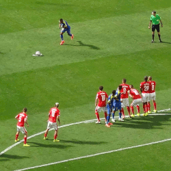 A defending team (red) attempts to block the direct path to goal with a "wall" of players.