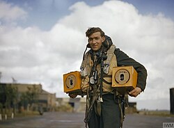 Crewman of an RAF Bomber with homing pigeons nestled in niches as a means of emergency communications in the event of a crash, ditching, or radio failure