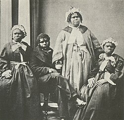 Four elderly full-blood Tasmanian Aboriginal people, c. 1860s. Truganini, for many years claimed to be the last full-blood Aboriginal person to survive, is seated far right.