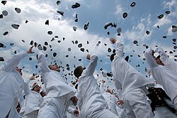 Newly commissioned officers celebrate their new positions by throwing their midshipmen covers into the air as part of the U.S. Naval Academy class of 2005 graduation and commissioning ceremony.