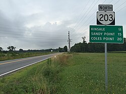 View north along Virginia State Route 203 (Oldhams Road) at Virginia State Route 3 (Kings Highway-History Land Highway) in Lyells.