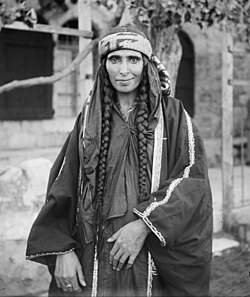 Arab Christian Bedouin woman from the settled town of Kerak, Jordan, who probably was the wife of a sheikh. Braids were predominantly worn by Arab Christian Bedouin women of the tribes of Jordan.[17]