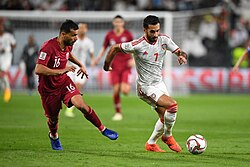 Boualem Khoukhi competes with Ali Mabkhout for the ball.