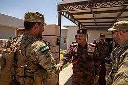 A Syrian military officer meets with an officer from the Iraqi Border Force Command.