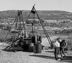 Israeli geologist Leo Picard (white shirt) inspects a drilled water well outside the depopulated Palestinian village of Bayt Naqquba
