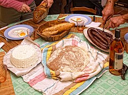 A traditional Corsican meal with (from left to right): brocciu, pulenda, and figatellu