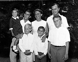 Bush, top right, standing with his wife and children, mid-1960s