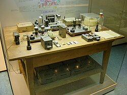 This set up is on display in the Deutsches Museum in Munich. The table and instruments are original, but the instruments would not have been together on the one table in the same room.[73] Pressure from historians, scientists and feminists caused the museum to alter the display in 1988 to acknowledge Lise Meitner, Otto Frisch and Fritz Strassmann.[74]