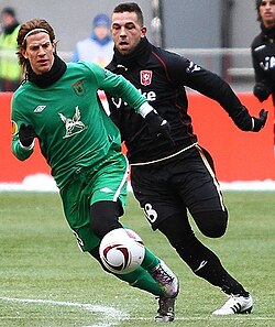 Ansaldi (left) with Rubin Kazan, chased down by Theo Janssen (right) of Twente, February 2011.