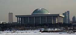National Assembly Building with the 63 building in the background (left)