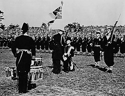 George VI presents the King's Colours to the Royal Canadian Navy at a ceremony in Beacon Hill Park, Victoria, in 1939