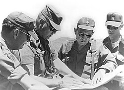 Schwarzkopf, then a colonel, consults with other officers during a training mission in California in 1977