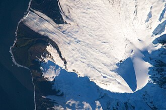 Satellite image of the southern tip of Heard Island. Cape Arkona is seen on the left side of the image, with Lied Glacier just above and Gotley Glacier just below. Big Ben Volcano and Mawson Peak are seen at the lower right side of the image.