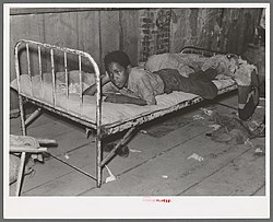 African American boy in a sharecropper shack, New Madrid County, 1938