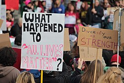 "What happened to 'All Lives Matter'?" sign at a protest against Donald Trump, January 29, 2017