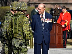 Prince Philip, Duke of Edinburgh, wearing at the neck the insignia of a Companion of the Order of Canada. Philip originally declined an honorary appointment to the Order of Canada, feeling the offer implied he was a foreigner to Canada. In April 2013, he accepted appointment as the first extraordinary Companion.