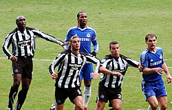 Drogba (back centre) preparing for a corner kick against Newcastle United in November 2010