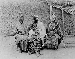 A Toucouleur interpreter called Alpha Sega with his sisters. Image taken in 1882.