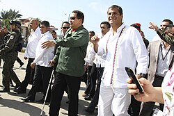 Chávez walking with a cane accompanied by Ecuadorian president Rafael Correa in Caracas in July 2011, shortly after his first cancer surgery