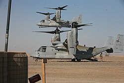 Two U.S. Marine Corps MV-22s of VMM-161 land at a forward operating base in Afghanistan, 2012