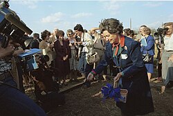 Lady Bird Johnson spreads seeds at the groundbreaking of the National Wildflower Research Center.